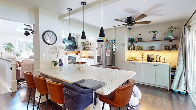 114 Shetland Dr, New City, NY 10956 - kitchen featuring stainless steel fridge, dark wood finished floors, a kitchen breakfast bar, a ceiling fan, and hanging light fixtures