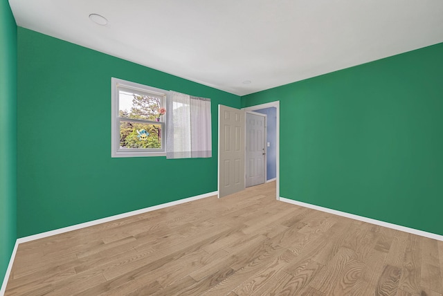 299 Orchid Dr, Mastic Beach, NY 11951 - unfurnished bedroom featuring wood finished floors and baseboards