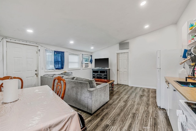 299 Orchid Dr, Mastic Beach, NY 11951 - dining space featuring wood finished floors, recessed lighting, vaulted ceiling, and cooling unit