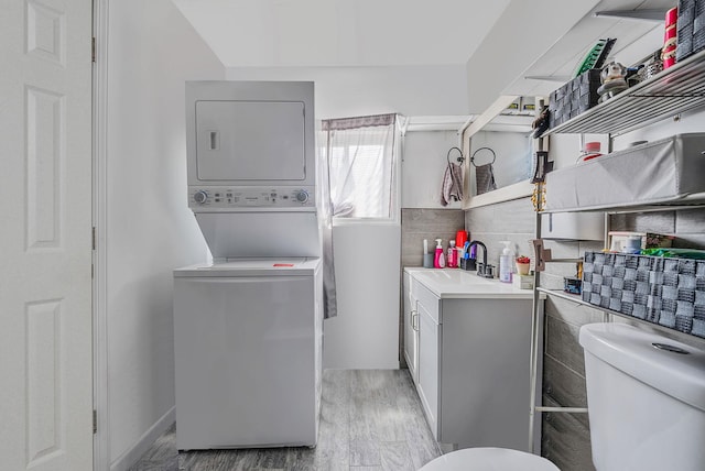 299 Orchid Dr, Mastic Beach, NY 11951 - laundry room featuring estacked washer and dryer and light wood finished floors