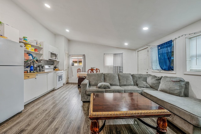299 Orchid Dr, Mastic Beach, NY 11951 - living room featuring lofted ceiling, light wood-style flooring, and recessed lighting