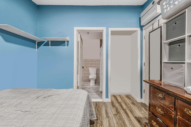 299 Orchid Dr, Mastic Beach, NY 11951 - bedroom with wood finished floors and tile walls
