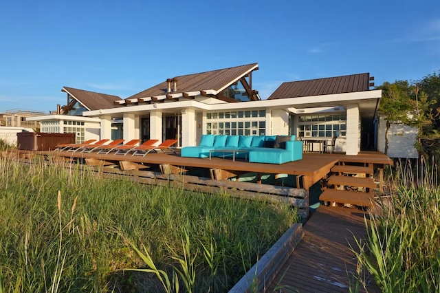 230 Bay Walk, Fire Island Pines, NY 11782 - back of property featuring a wooden deck, a metal roof, and outdoor lounge area