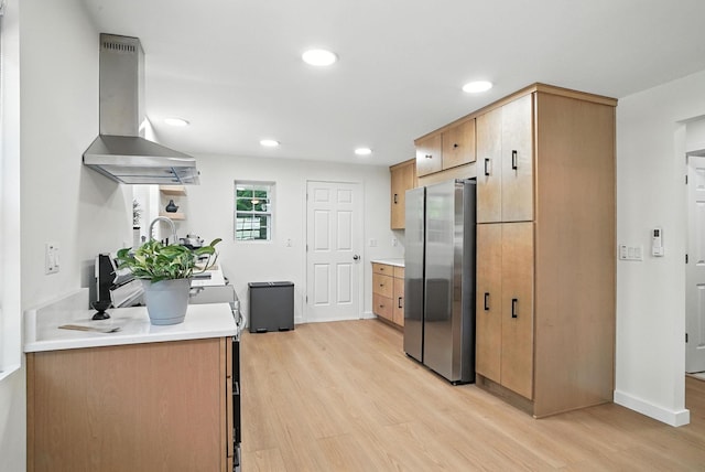 7 Fayer Ct, Phillipsport, NY 12790 - kitchen with freestanding refrigerator, wall chimney exhaust hood, light wood-style flooring, light countertops, and recessed lighting