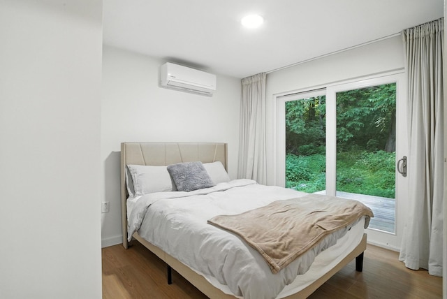 7 Fayer Ct, Phillipsport, NY 12790 - bedroom with a wall mounted air conditioner, wood finished floors, access to exterior, and recessed lighting