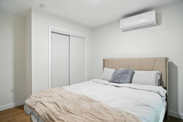 7 Fayer Ct, Phillipsport, NY 12790 - bedroom featuring a wall mounted AC, wood finished floors, and a closet