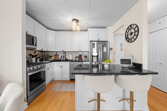 3220 Fairfield Ave Unit 6A, Bronx, NY 10463 - kitchen with stainless steel appliances, a kitchen bar, and white cabinets