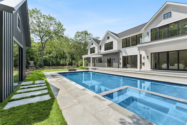 7 Rosemary Ln, Sag Harbor, NY 11963 - view of swimming pool with a pool with connected hot tub and a patio