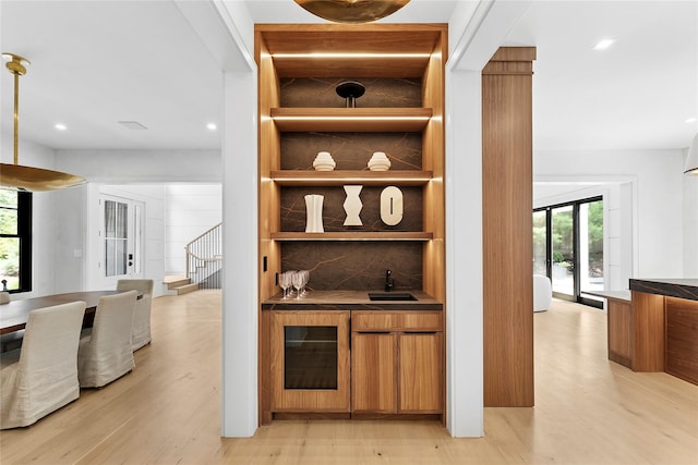 7 Rosemary Ln, Sag Harbor, NY 11963 - indoor wet bar featuring wine cooler, plenty of natural light, light wood finished floors, recessed lighting, and stairs