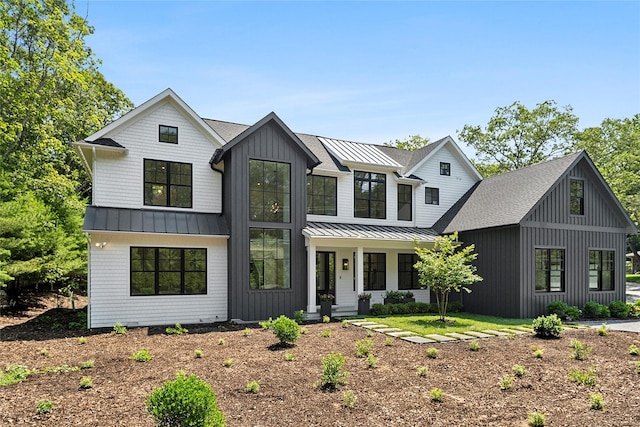 7 Rosemary Ln, Sag Harbor, NY 11963 - modern farmhouse featuring a standing seam roof, covered porch, board and batten siding, a shingled roof, and a metal roof