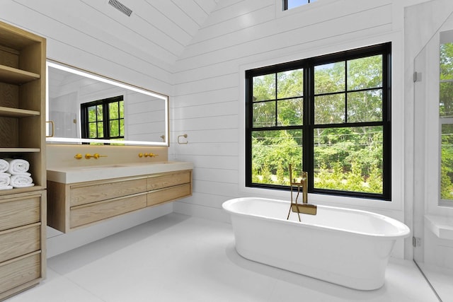 7 Rosemary Ln, Sag Harbor, NY 11963 - full bath with vanity, a freestanding tub, and wood walls