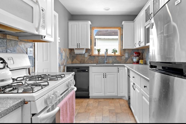 881 Surf St, Lindenhurst, NY 11757 - kitchen with white appliances, tasteful backsplash, white cabinetry, light stone finish floors, and light countertops