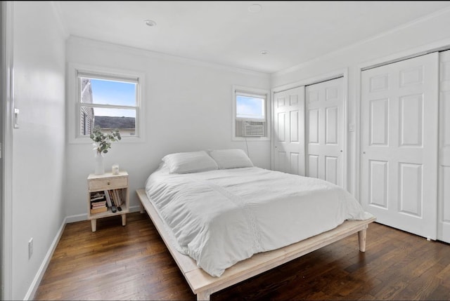 881 Surf St, Lindenhurst, NY 11757 - bedroom featuring ornamental molding, dark wood-style flooring, multiple closets, and cooling unit