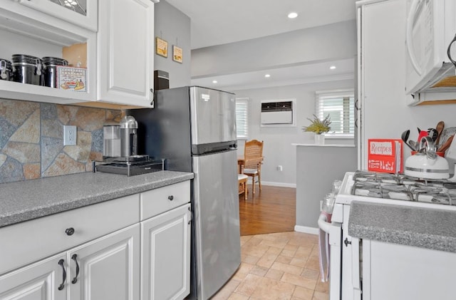 881 Surf St, Lindenhurst, NY 11757 - kitchen with white appliances, white cabinets, decorative backsplash, light stone finish floors, and recessed lighting