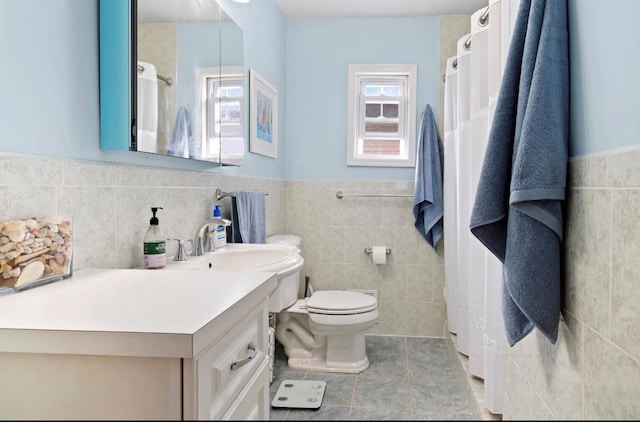881 Surf St, Lindenhurst, NY 11757 - bathroom with tile walls, vanity, and wainscoting
