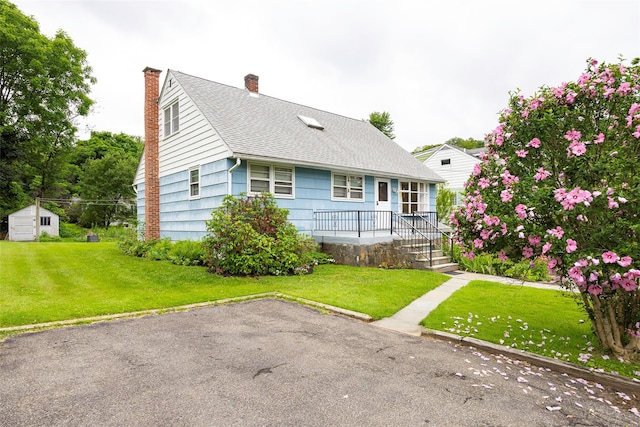 511 Walnut St, Hurley, NY 12443 - view of front of home featuring a storage unit, a shingled roof, a chimney, and a front yard