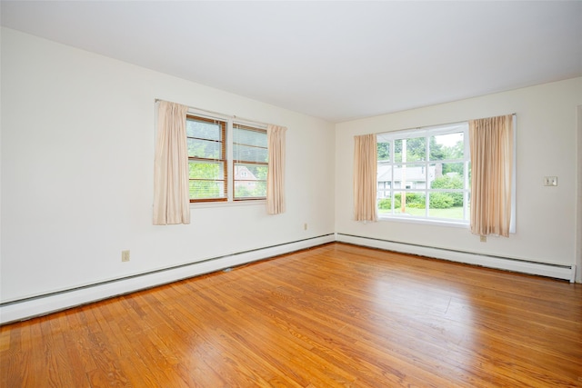 511 Walnut St, Hurley, NY 12443 - unfurnished room featuring a baseboard radiator, a baseboard heating unit, and wood finished floors