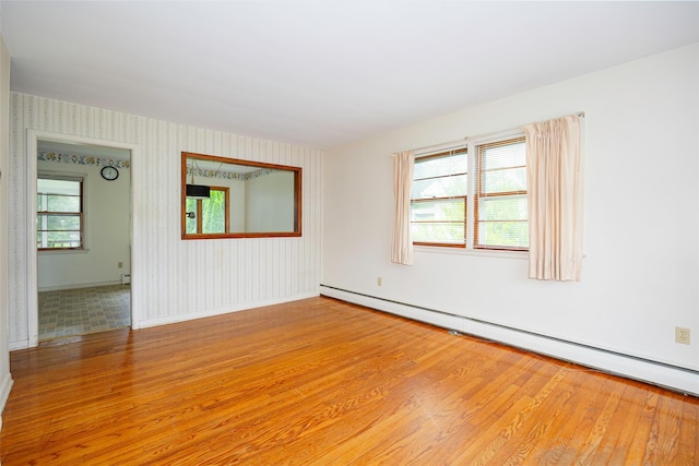 511 Walnut St, Hurley, NY 12443 - unfurnished room featuring light wood-style floors, wallpapered walls, and a baseboard radiator