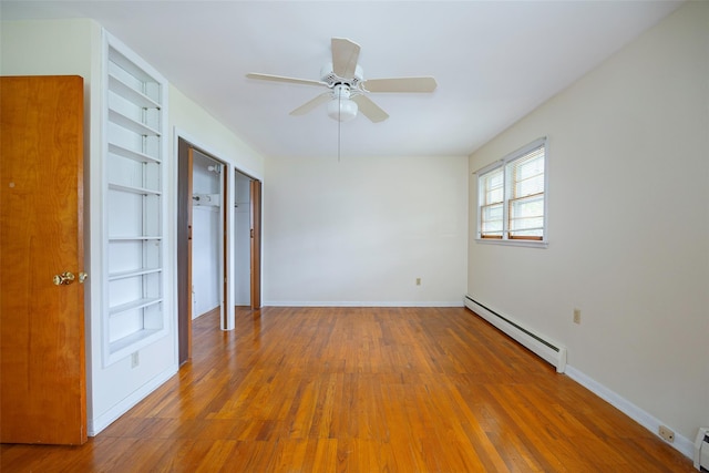 511 Walnut St, Hurley, NY 12443 - empty room featuring baseboard heating, wood finished floors, ceiling fan, and built in shelves