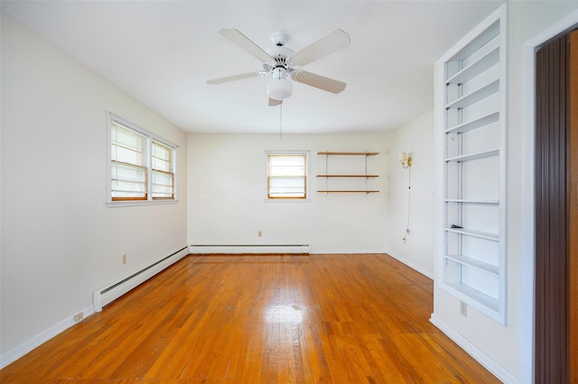 511 Walnut St, Hurley, NY 12443 - empty room featuring plenty of natural light, wood finished floors, baseboard heating, and ceiling fan