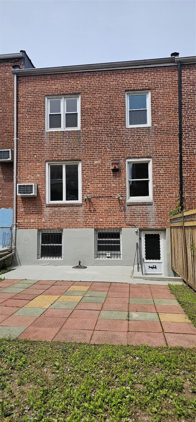 5203 72nd Pl, Maspeth, NY 11378 - rear view of property featuring brick siding and a wall unit AC