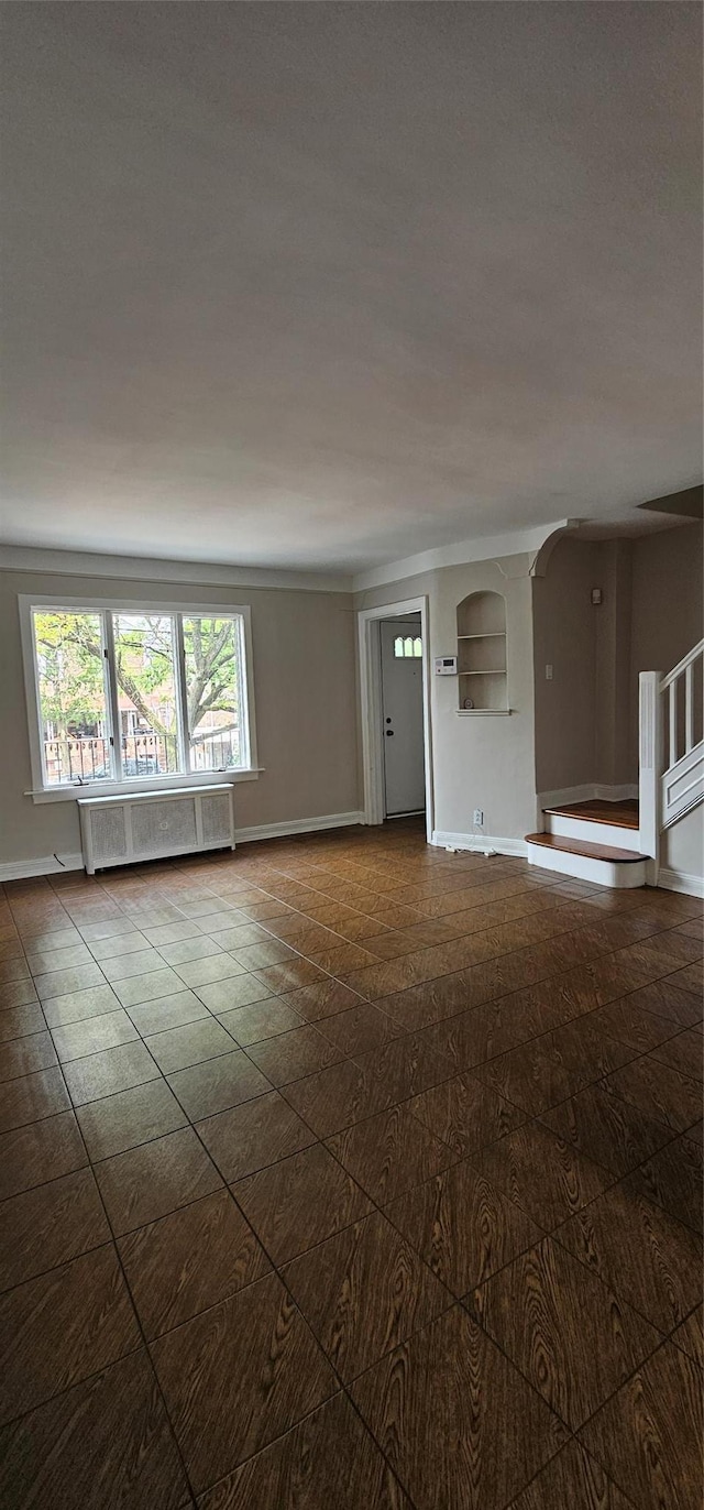 5203 72nd Pl, Maspeth, NY 11378 - unfurnished room with radiator heating unit and baseboards