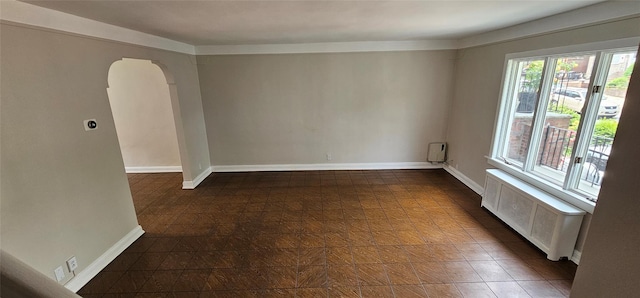 5203 72nd Pl, Maspeth, NY 11378 - spare room featuring radiator and arched walkways