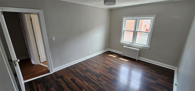 5203 72nd Pl, Maspeth, NY 11378 - spare room with radiator heating unit, dark wood-type flooring, and a textured ceiling