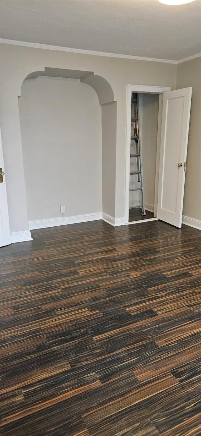 5203 72nd Pl, Maspeth, NY 11378 - unfurnished room with arched walkways, ornamental molding, and dark wood-type flooring