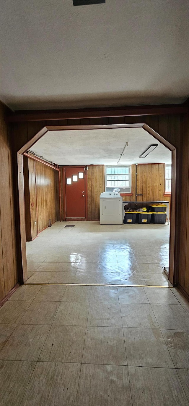 5203 72nd Pl, Maspeth, NY 11378 - hallway featuring wooden walls, healthy amount of natural light, and washing machine and clothes dryer