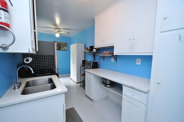 29 Abeel St Unit 4L, Yonkers, NY 10705 - kitchen featuring white cabinets, ceiling fan, light countertops, and tasteful backsplash