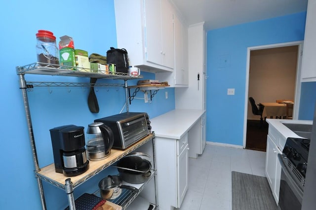29 Abeel St Unit 4L, Yonkers, NY 10705 - kitchen featuring gas range oven, white cabinets, light countertops, and open shelves