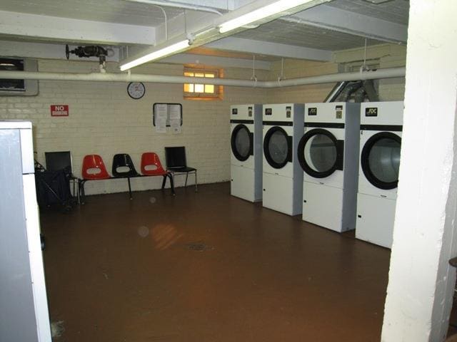 29 Abeel St Unit 4L, Yonkers, NY 10705 - communal laundry room with independent washer and dryer and brick wall