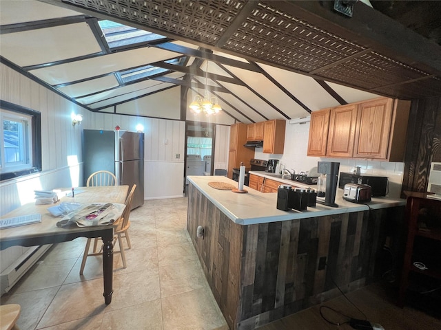 71 Keller Ave, Smallwood, NY 12778 - kitchen featuring appliances with stainless steel finishes, lofted ceiling, light countertops, under cabinet range hood, and a peninsula