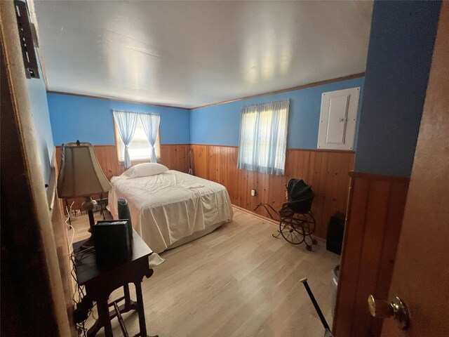 71 Keller Ave, Smallwood, NY 12778 - bedroom with a wainscoted wall, electric panel, wood walls, and wood finished floors