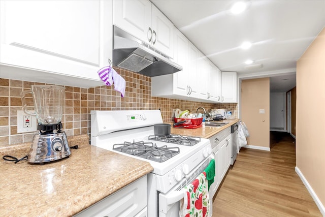 32-17 110, East Elmhurst, NY 11369 - kitchen featuring white range with gas stovetop, under cabinet range hood, light countertops, and white cabinets