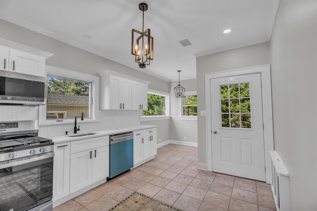 643 Deer Park Ave, Babylon, NY 11702 - kitchen featuring appliances with stainless steel finishes, light countertops, decorative backsplash, decorative light fixtures, and white cabinets