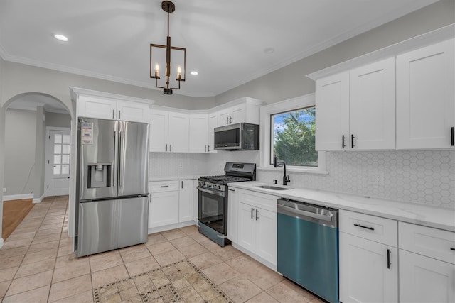 643 Deer Park Ave, Babylon, NY 11702 - kitchen featuring stainless steel appliances, arched walkways, white cabinetry, tasteful backsplash, and hanging light fixtures
