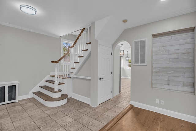 643 Deer Park Ave, Babylon, NY 11702 - stairway with arched walkways, healthy amount of natural light, crown molding, and tile patterned flooring