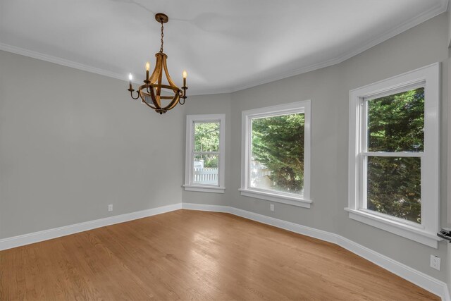 643 Deer Park Ave, Babylon, NY 11702 - unfurnished room featuring a chandelier, light wood-style flooring, and ornamental molding