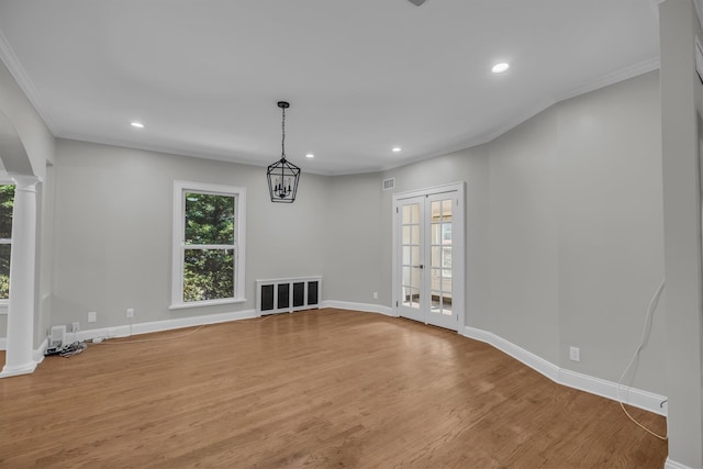 643 Deer Park Ave, Babylon, NY 11702 - unfurnished living room featuring wood finished floors, recessed lighting, crown molding, decorative columns, and french doors