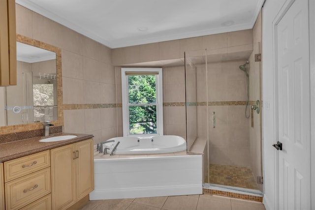 643 Deer Park Ave, Babylon, NY 11702 - bathroom featuring a garden tub, a stall shower, vanity, tile patterned floors, and tile walls