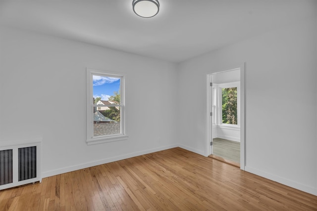 643 Deer Park Ave, Babylon, NY 11702 - empty room with light wood finished floors and radiator heating unit