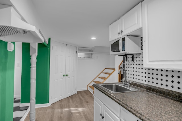 643 Deer Park Ave, Babylon, NY 11702 - kitchen with white microwave, dark countertops, white cabinetry, and recessed lighting