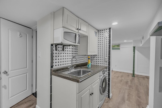 643 Deer Park Ave, Babylon, NY 11702 - kitchen with white microwave, dark countertops, white cabinets, light wood finished floors, and recessed lighting