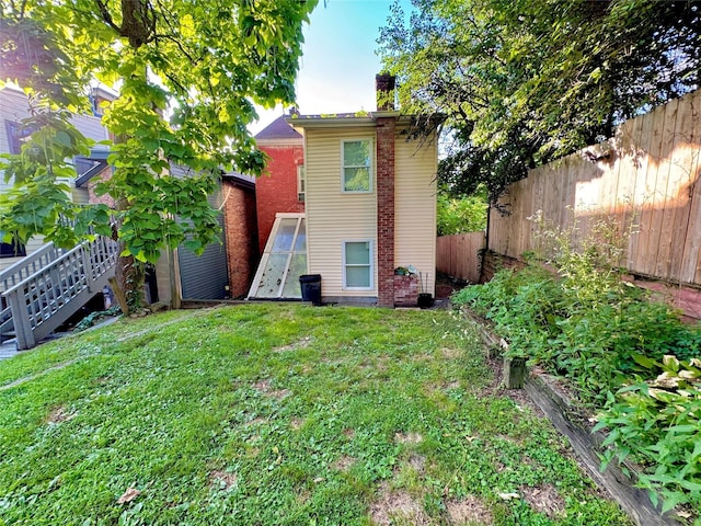 190 Union St, Poughkeepsie, NY 12601 - rear view of house featuring a fenced backyard and a chimney