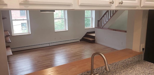 190 Union St, Poughkeepsie, NY 12601 - unfurnished living room featuring a baseboard radiator, wood finished floors, stairs, and beamed ceiling