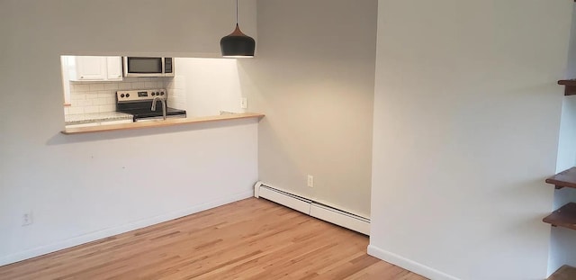 190 Union St, Poughkeepsie, NY 12601 - unfurnished dining area with a baseboard radiator and light wood finished floors