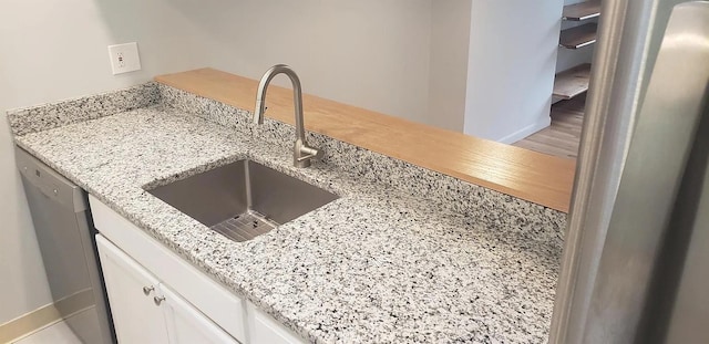 190 Union St, Poughkeepsie, NY 12601 - kitchen view of stainless steel dishwasher, white cabinets, and light stone counters