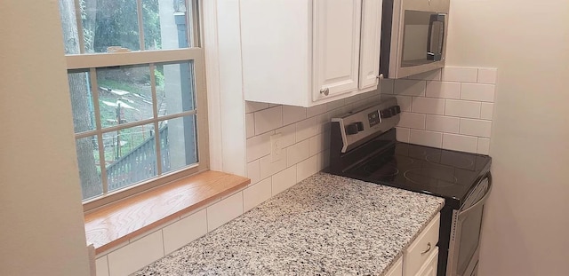 190 Union St, Poughkeepsie, NY 12601 - kitchen with appliances with stainless steel finishes, tasteful backsplash, white cabinets, and light stone countertops